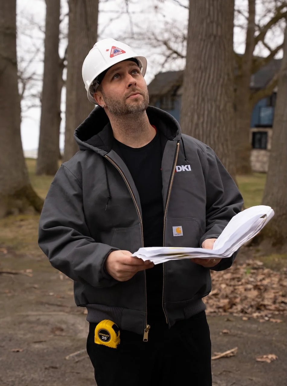 DKI project manager documenting roof leak damage for an insurance claim